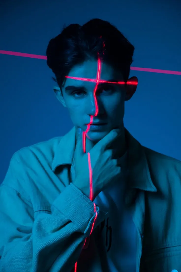 A red laser line across a blue portrait — men's portrait