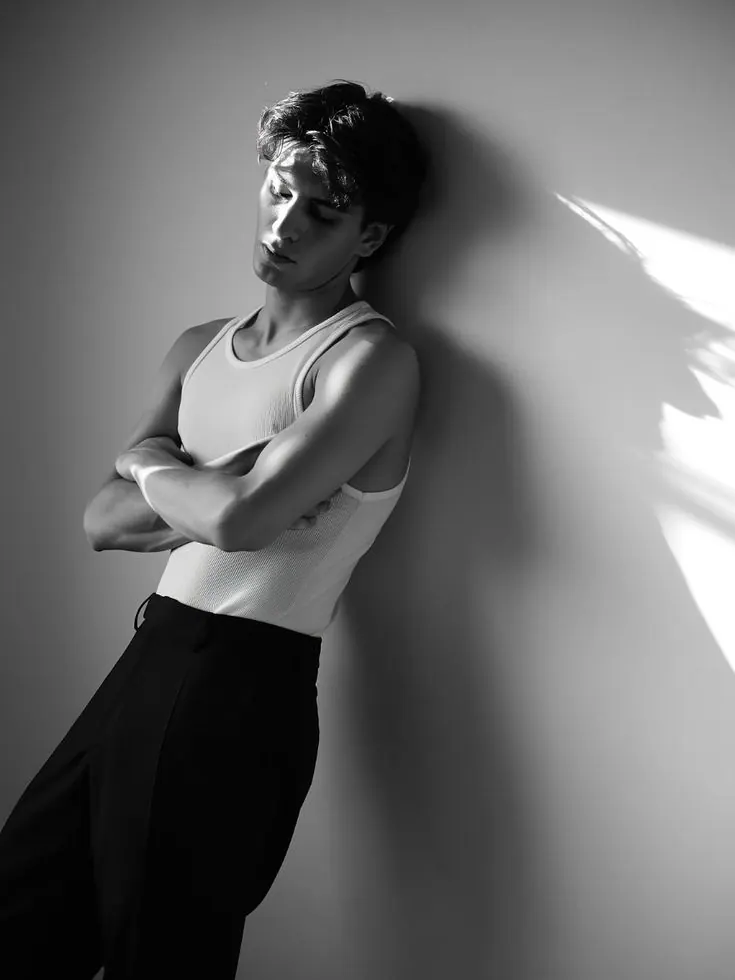 A white tank top in monochrome window light — men's portrait