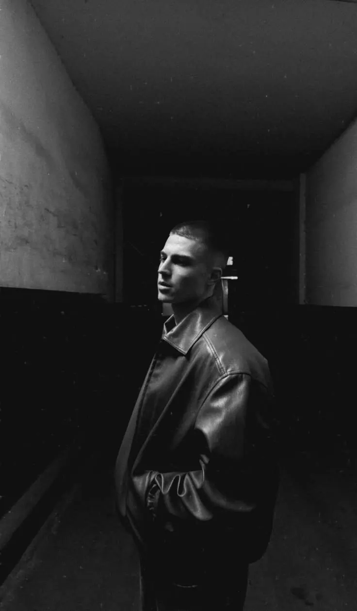 A suit in a dark doorway — men's portrait