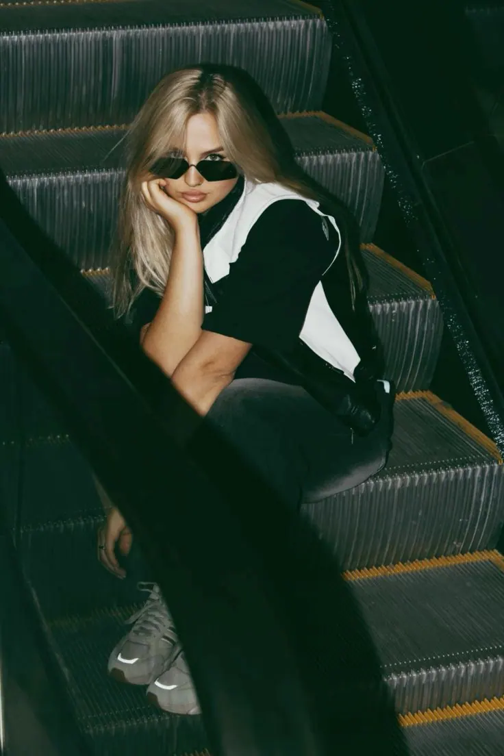 Un look negro en una escalera mecánica desde arriba — retrato de mujer