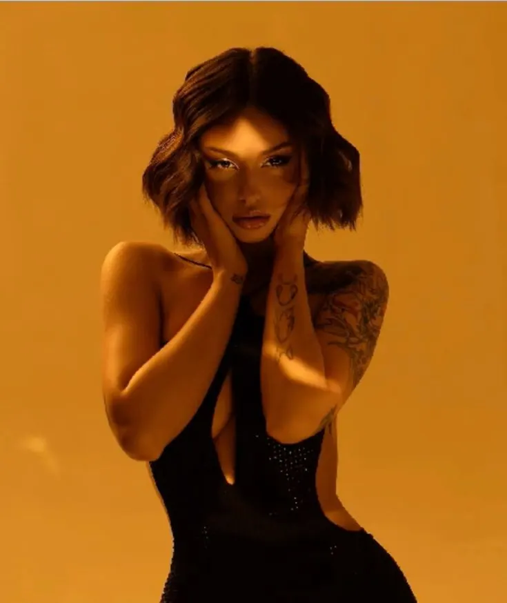 A black dress on an orange backdrop — women's portrait