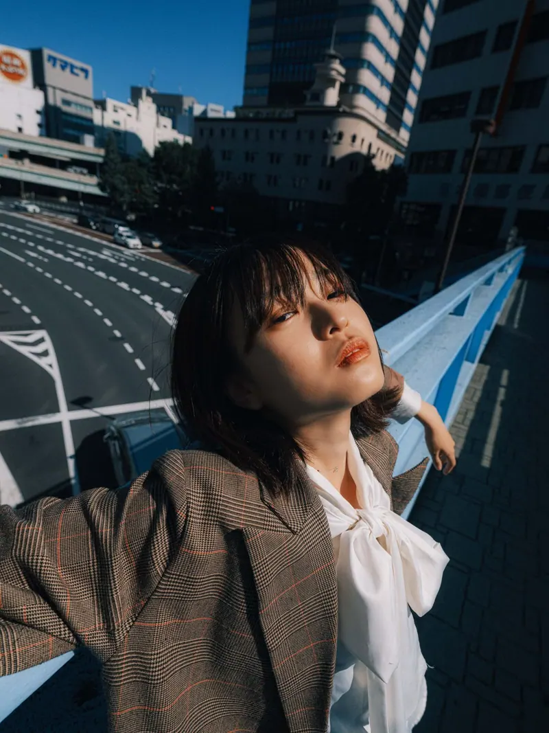 A business look beneath a city flyover — women's portrait
