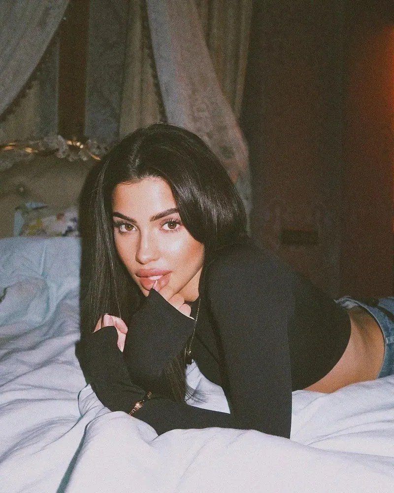 A black and white look on a bed — women's portrait