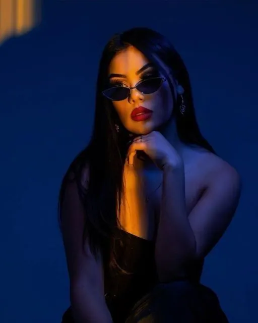 Blue and orange light with sunglasses — women's portrait