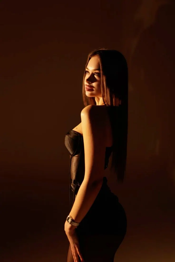 A profile in warm rim light — women's portrait