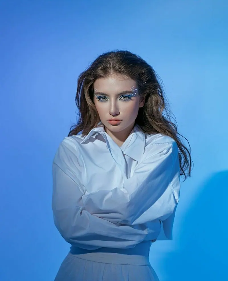 Wet hair and a white shirt in blue light — women's portrait