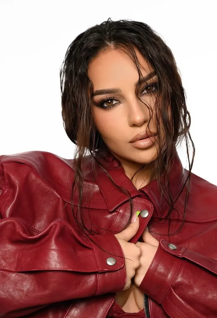 A red leather jacket on white — women's portrait