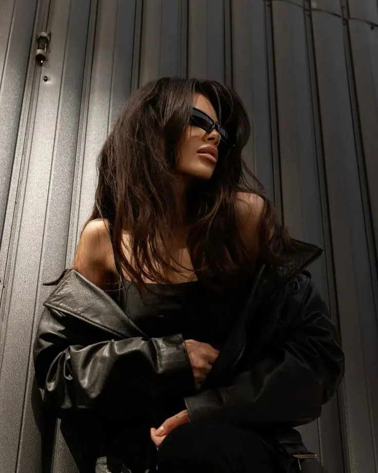 Black leather and a steel wall — women's portrait