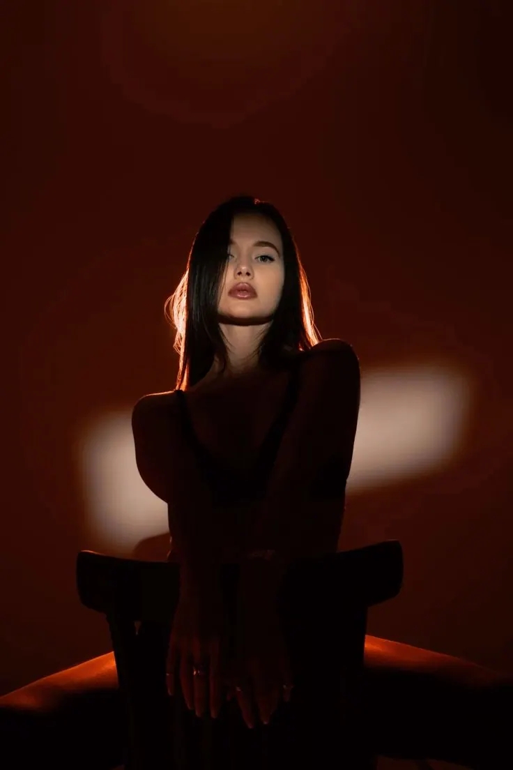 A chair in red and black light — women's portrait