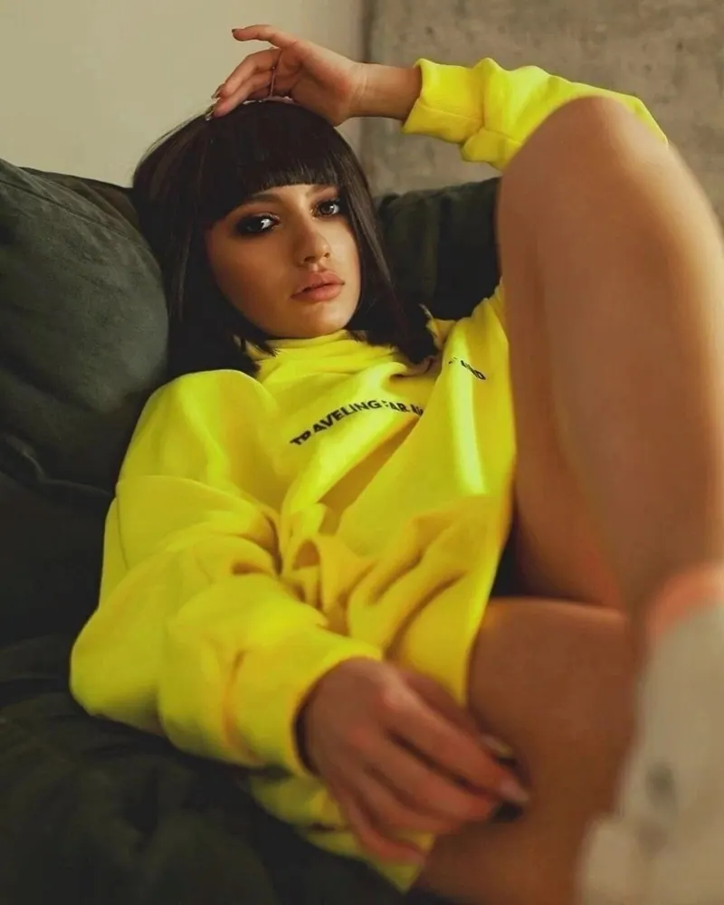 A neon tee and a relaxed pose — women's portrait