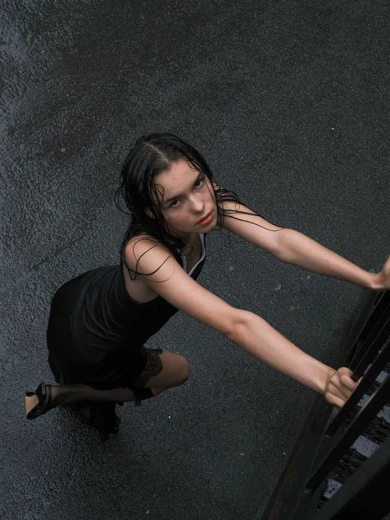 A black dress on an outdoor staircase — women's portrait