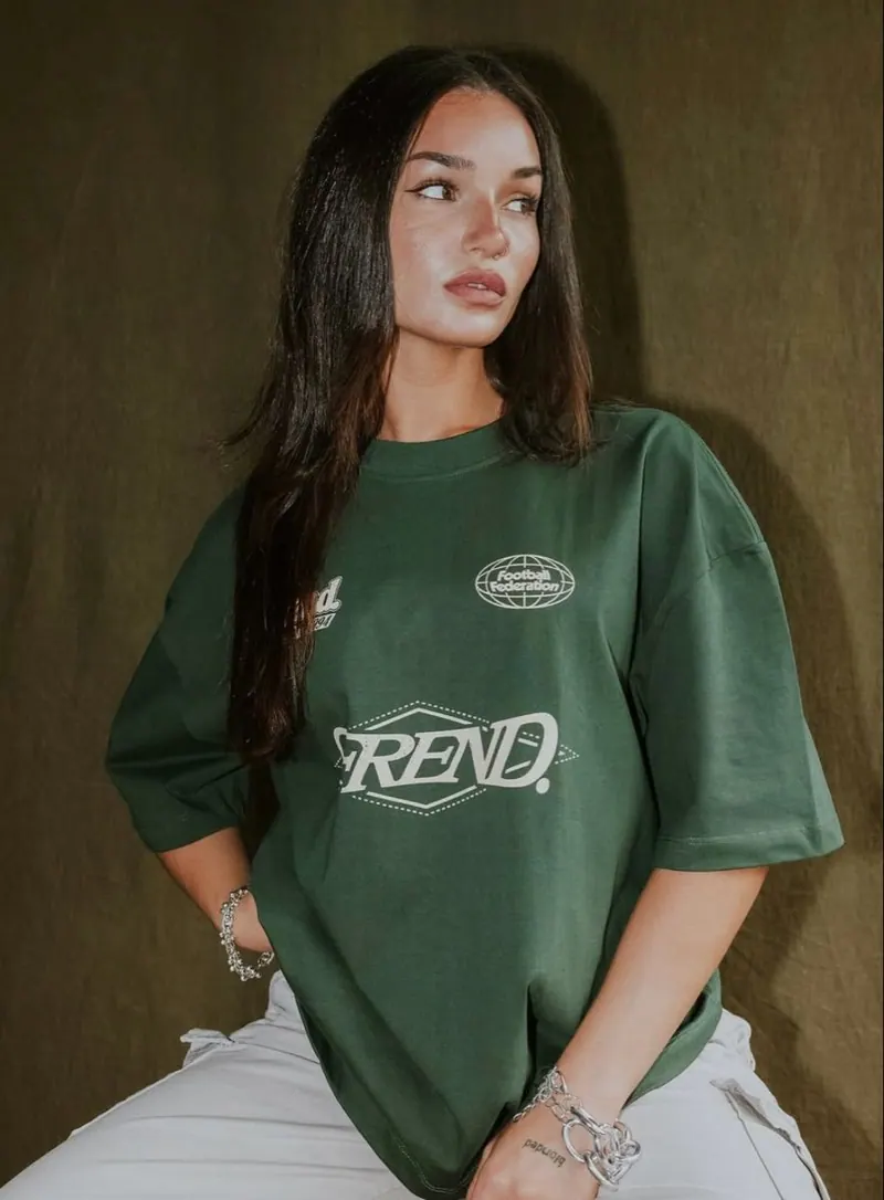 A green oversized tee with warm flash — women's portrait