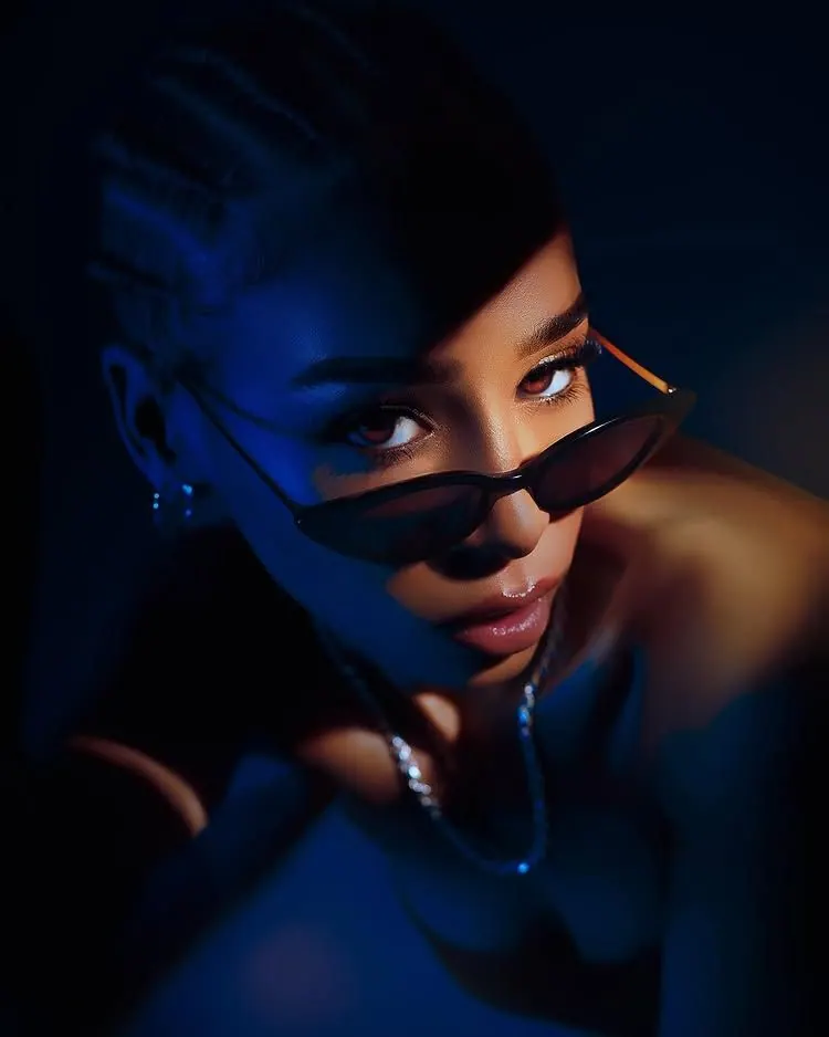 A close-up in electric blue light — women's portrait