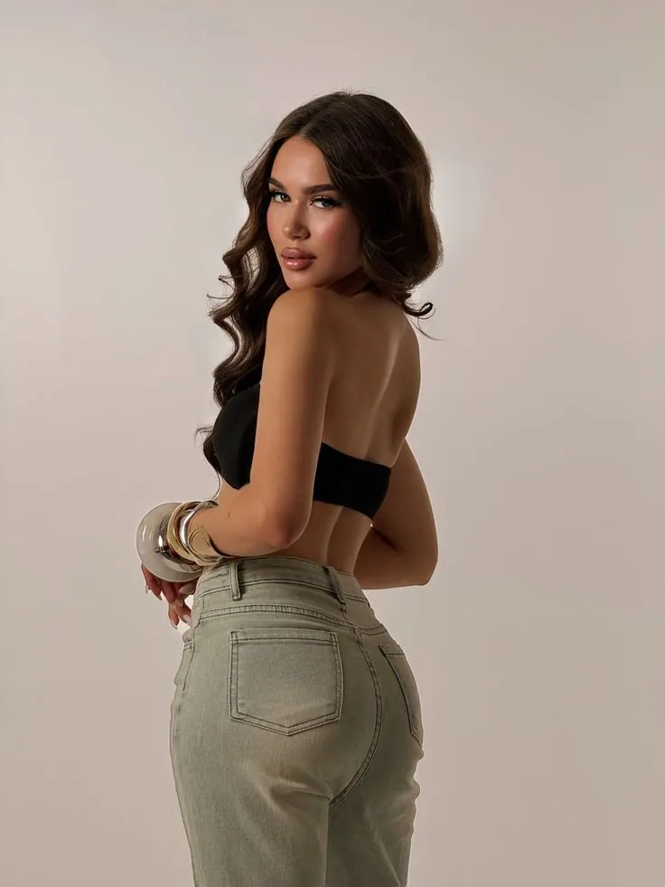 Khaki trousers against a beige backdrop — women's portrait