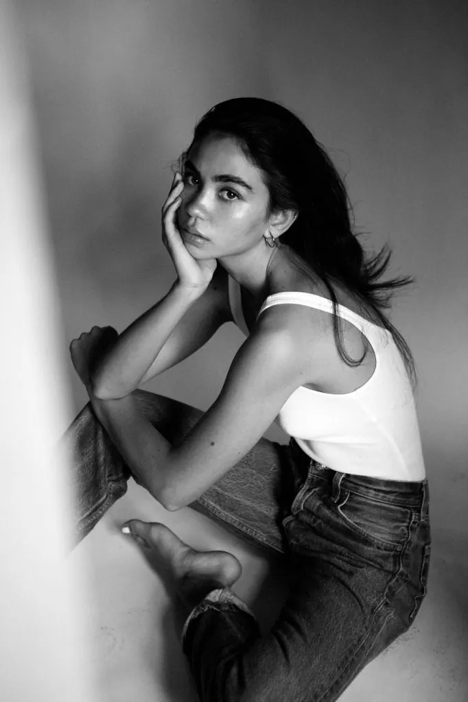 A seated black and white studio portrait — women's portrait