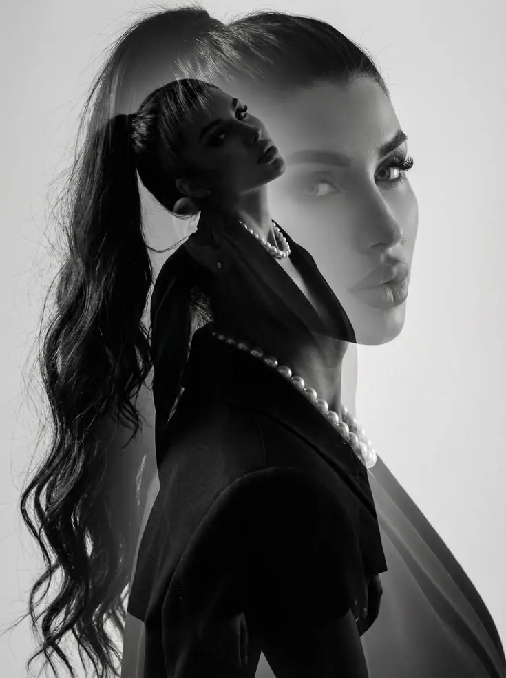 A high ponytail and black bow in monochrome — women's portrait