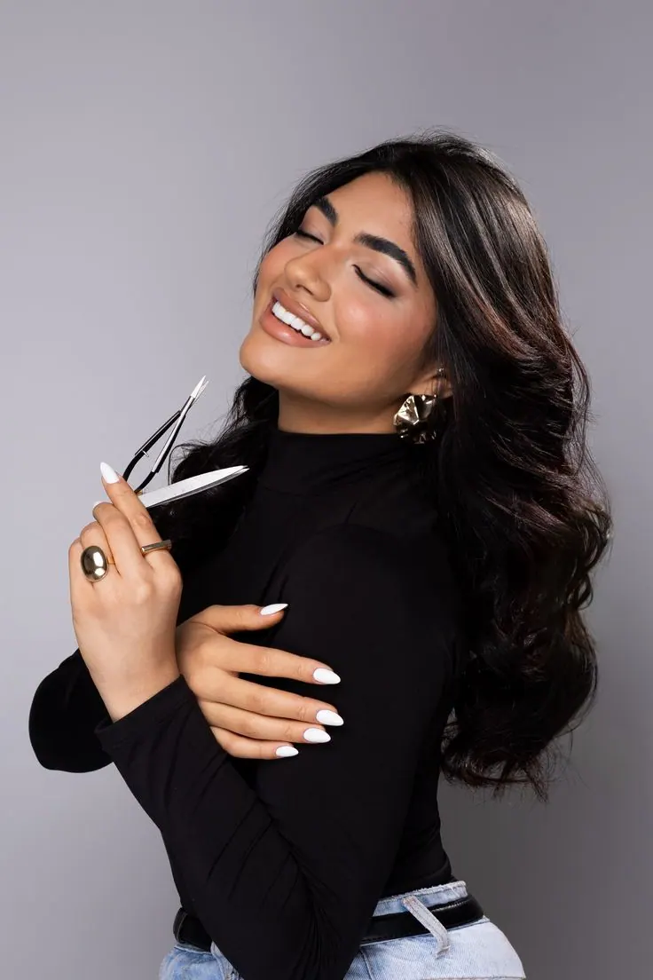 Makeup artist photoshoot — a makeup brush and a smiling beauty portrait