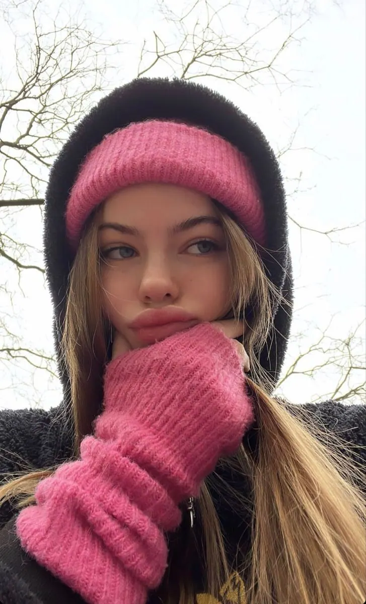 A pink hat and scarf outdoors in winter — women's portrait