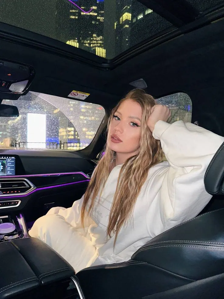 A white shirt inside a car with ambient lights — women's portrait