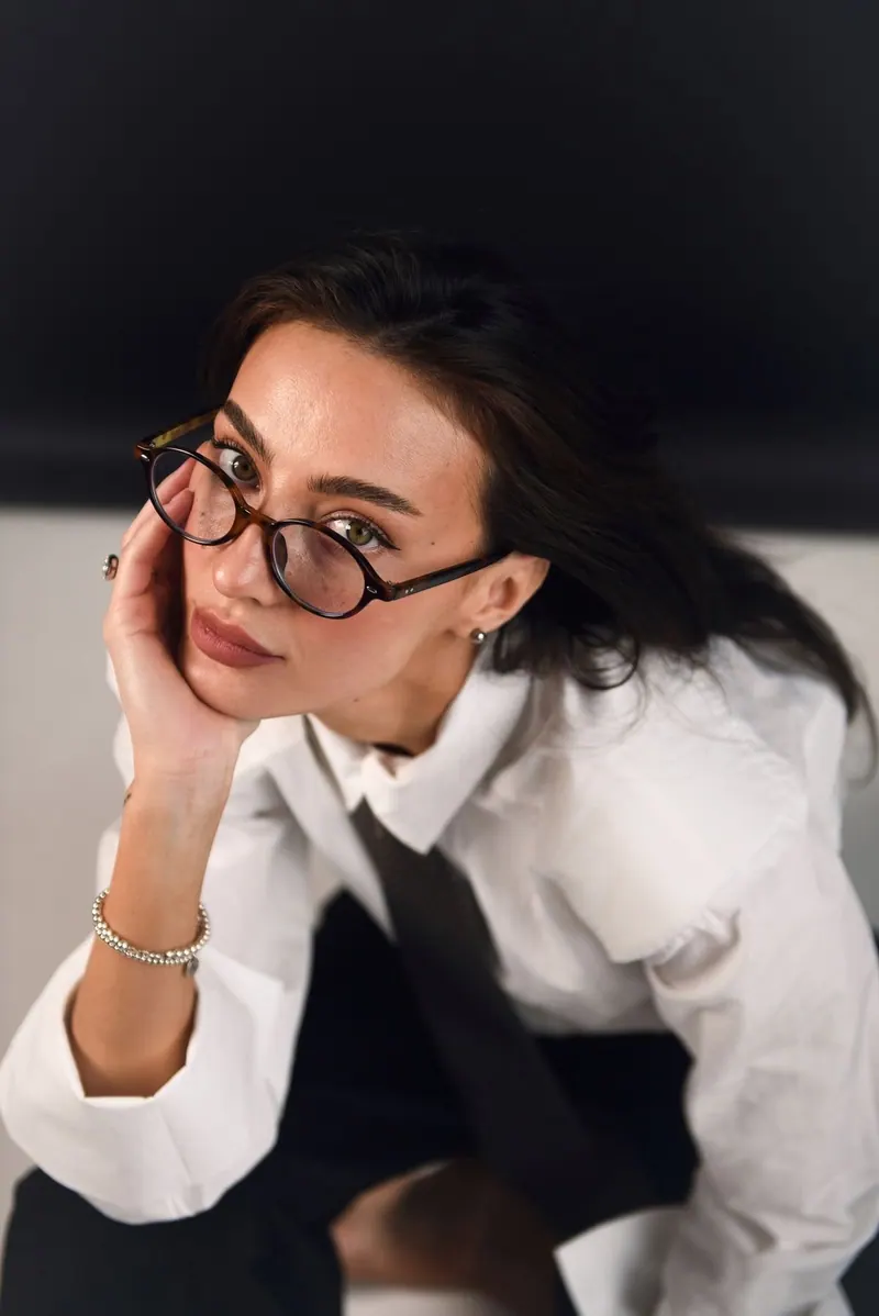 A white shirt with tie and glasses — women's portrait