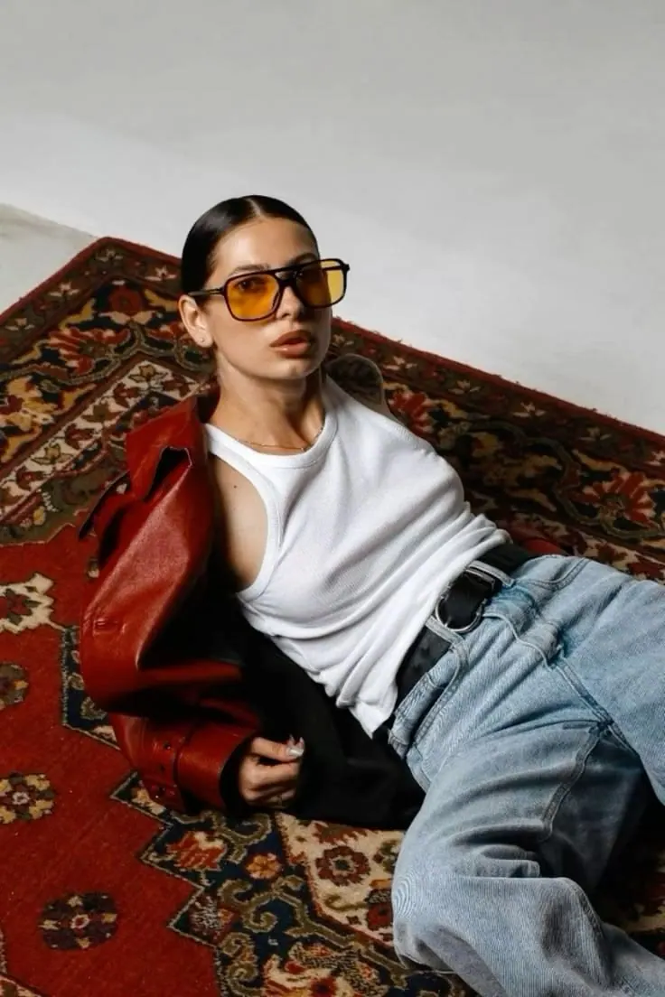 A leather jacket over a patterned rug — women's portrait