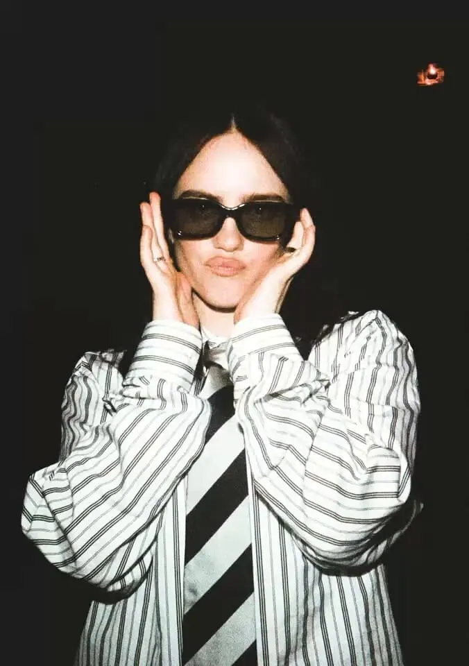 A striped suit and dark sunglasses — women's portrait