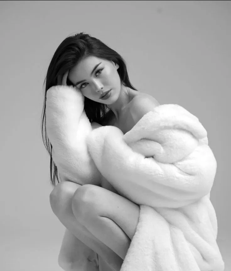 A white fur coat in a black and white portrait — women's portrait