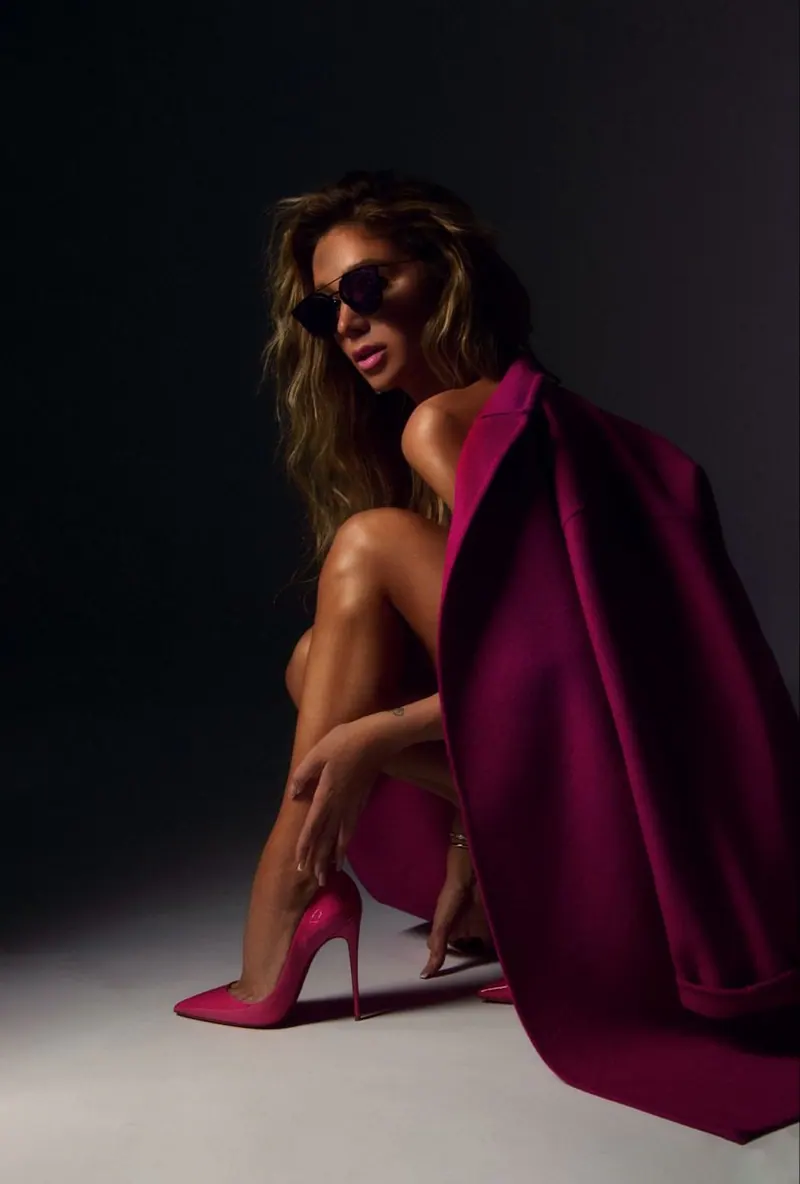A bright pink dress and flowing fabric in the dark — women's portrait