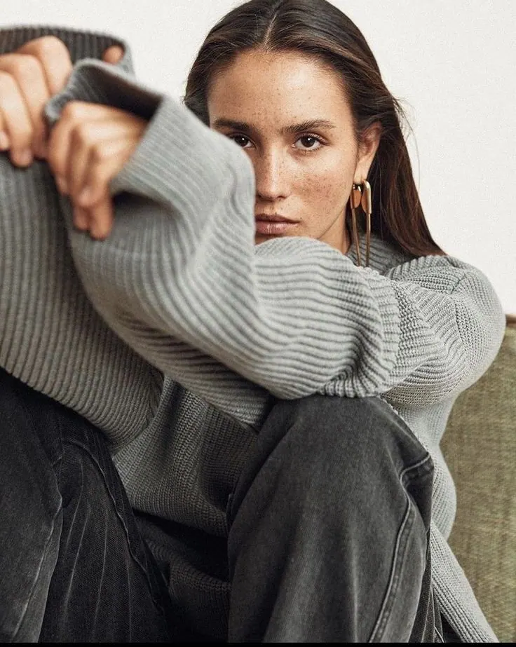 Un jersey gris en una pose sentada relajada — retrato de mujer