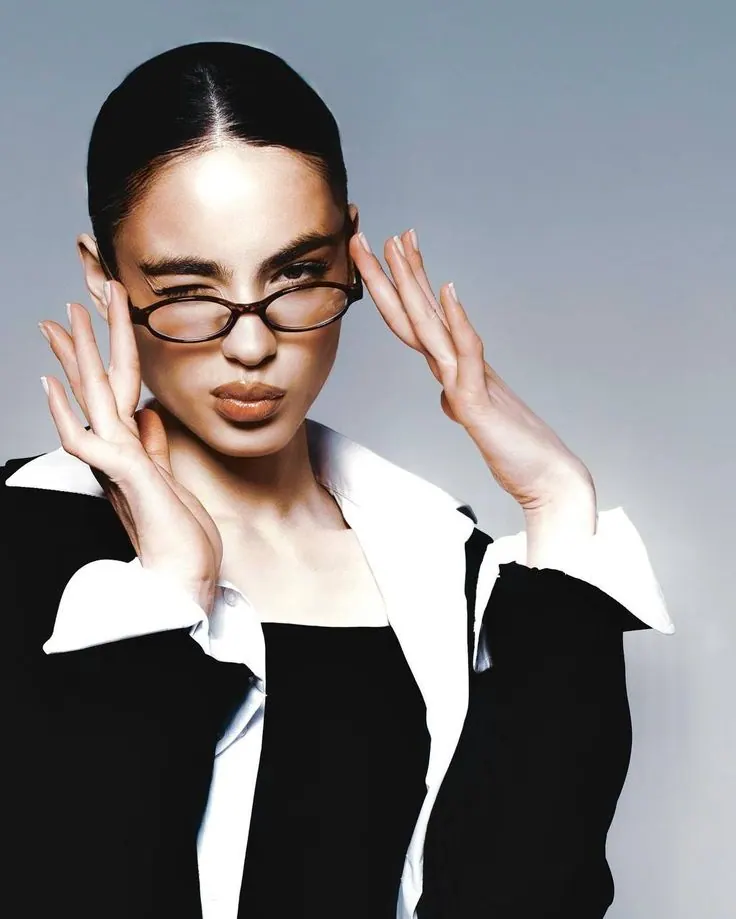 A graphic black and white suit with narrow glasses — women's portrait